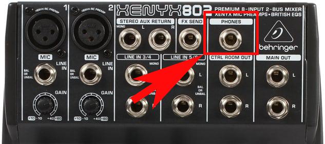 Image shows the top part of a live mixer, with the headphones output highlighted by a red arrow and box.
